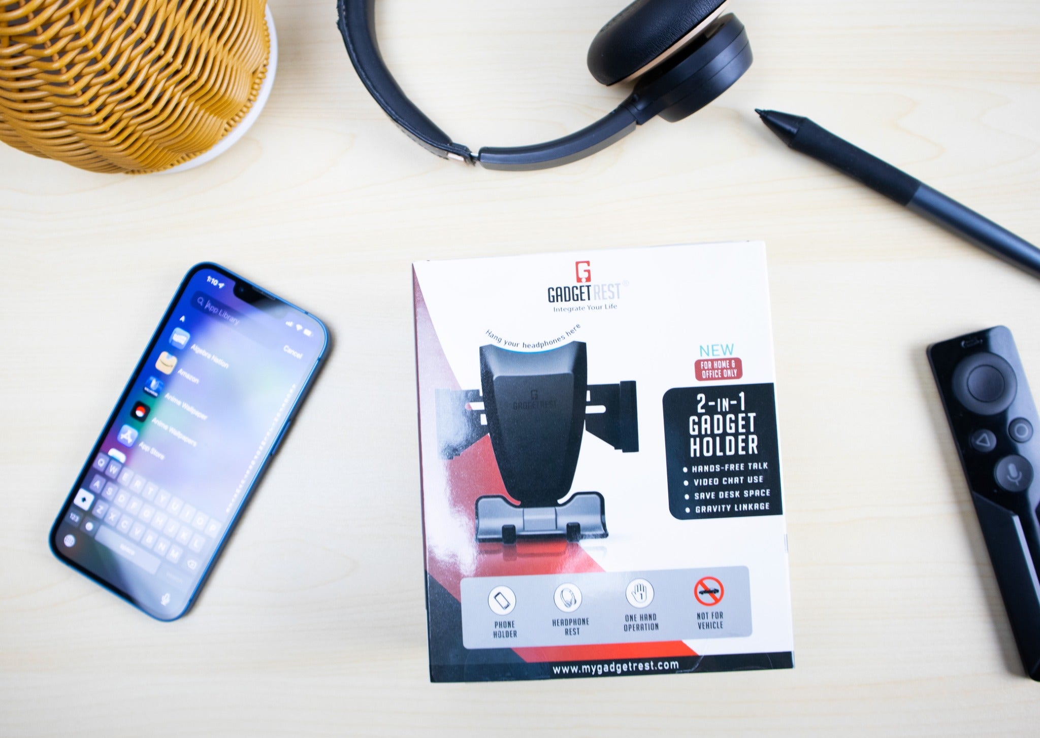 GadgetRest packaging arranged on a desk with a phone and headphones